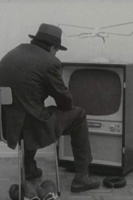 For Gerry Schum’s “Identifications,” Beuys re‑created his 1966 “Felt TV” Happening for the camera, the only action he performed expressly for television. The film opens with him seated before a TV whose screen is covered by felt, rendering the programme invisible. Beneath his chair, boxing gloves lie ready, later entering the action.